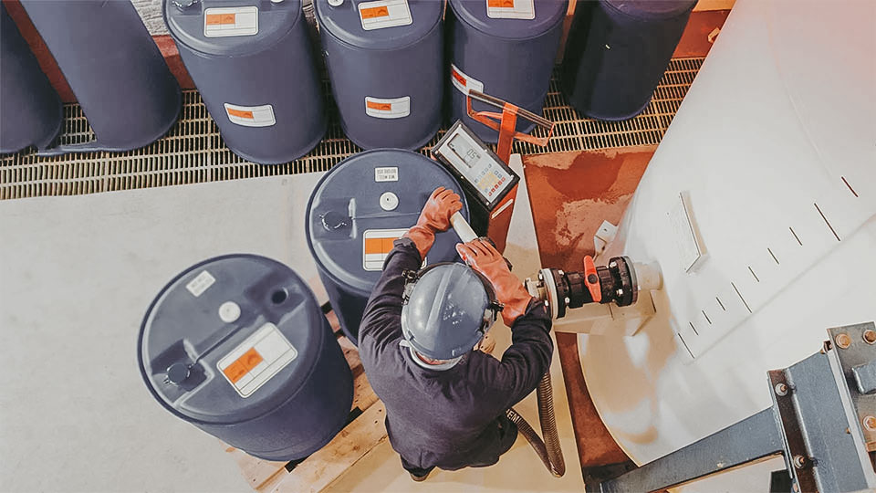 Chemical Management worker with chemical containers