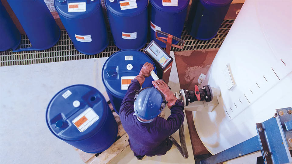 Chemical Management worker with chemical containers