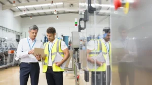 Manufacturing plant staff looking at tablet