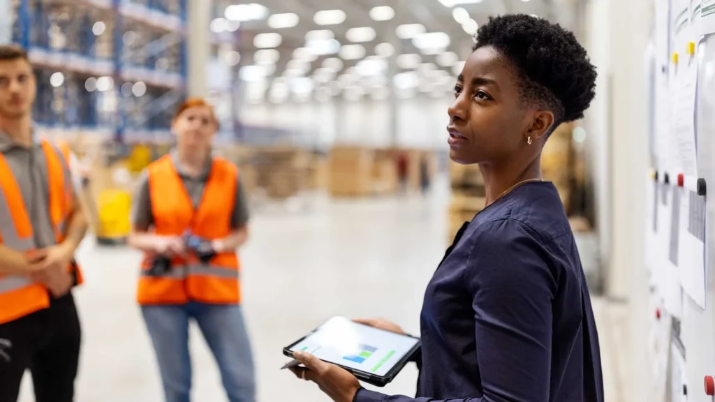 Safety meetings in the workplace. Supervisor leads a safety meeting on warehouse floor.