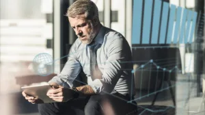 Man at office focused on device