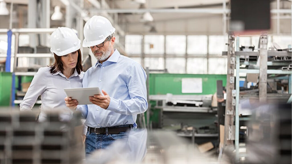 Workers Checking Info on Tablet