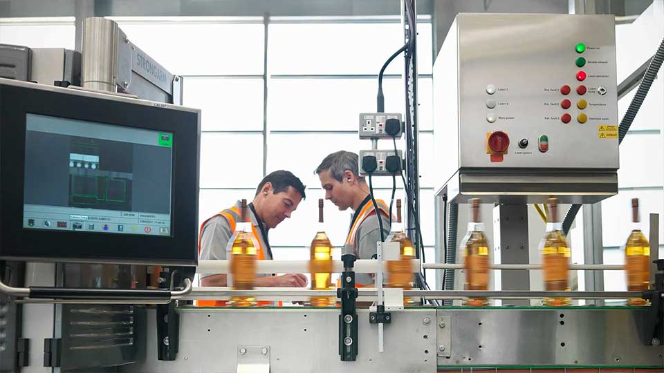 Bottling Factory Workers On Assembly Line