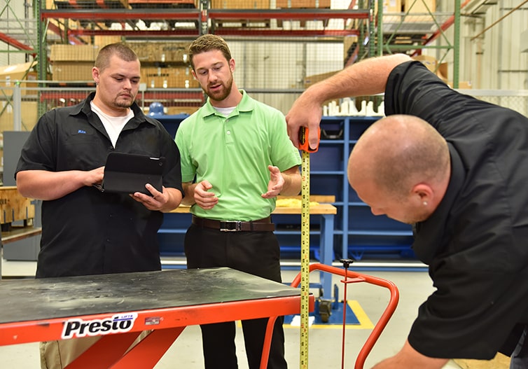 Industrial Workers Taking Measurements