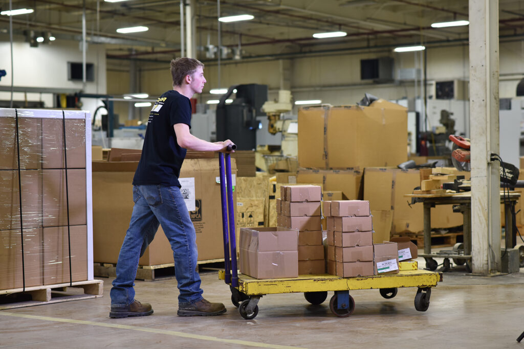 Employee handling materials with manual machine