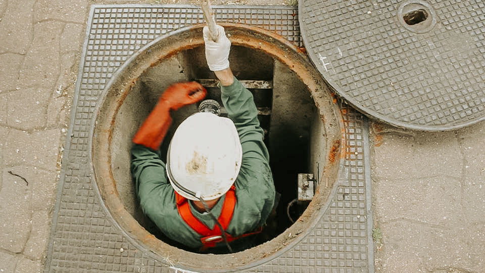 Worker in a drainage hole