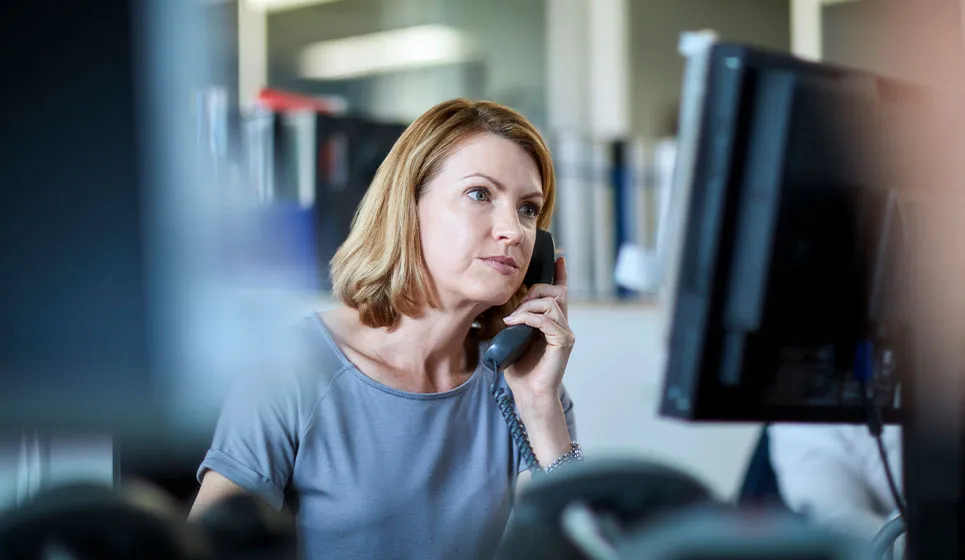 Woman on phone call at workstation