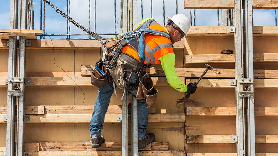 Constuction worker held by bungee cord