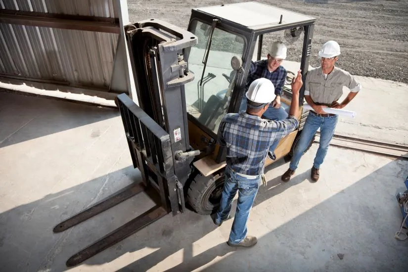 3 Male Employees Gathered Around A Pit