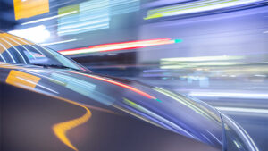 Streaking reflections on car surface and streaking city-background