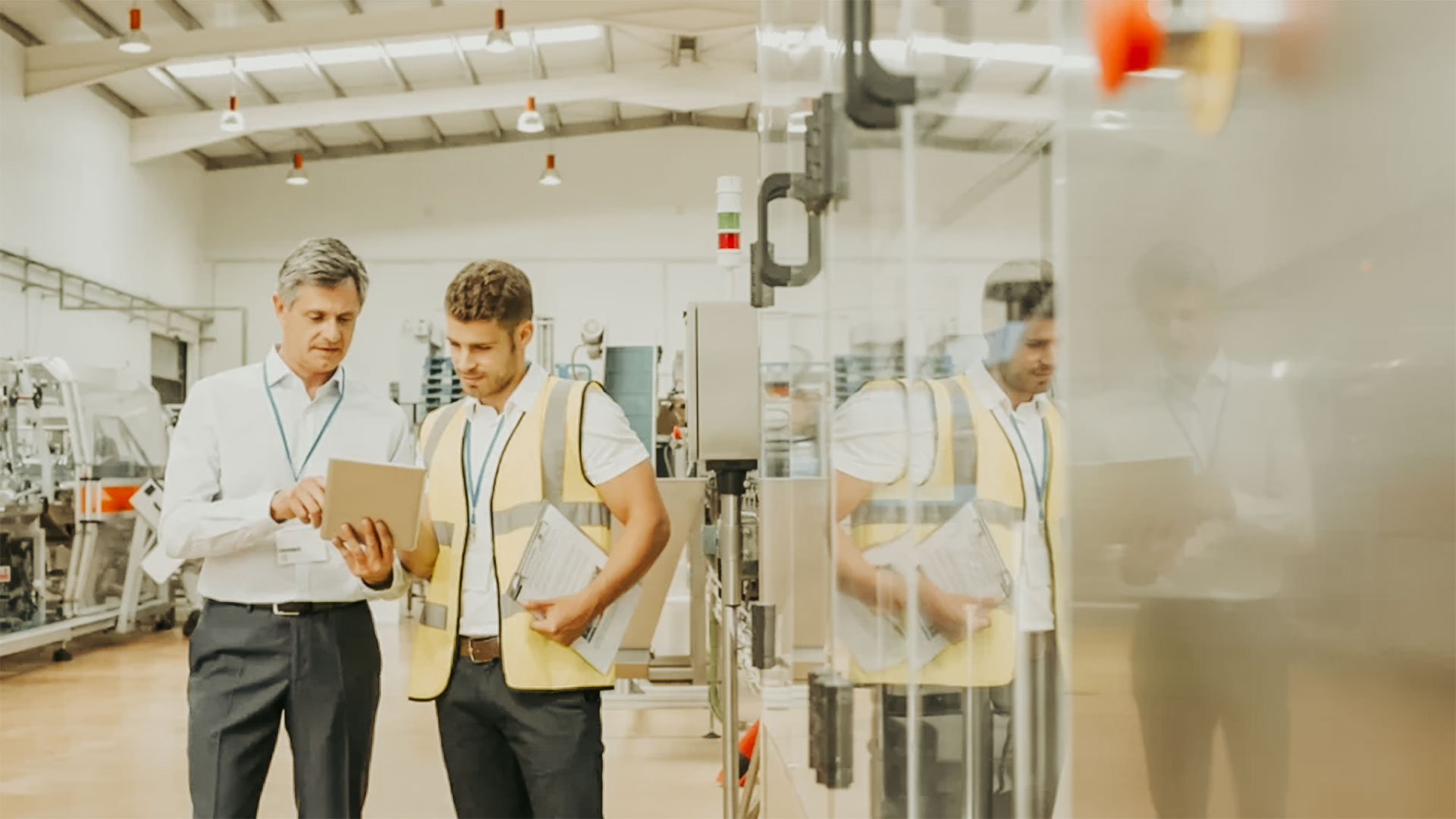 Manufacturing plant staff looking at tablet