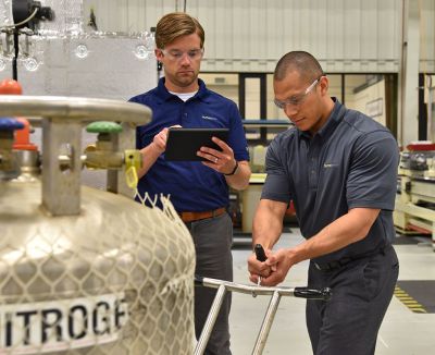 man observing worker using equipment