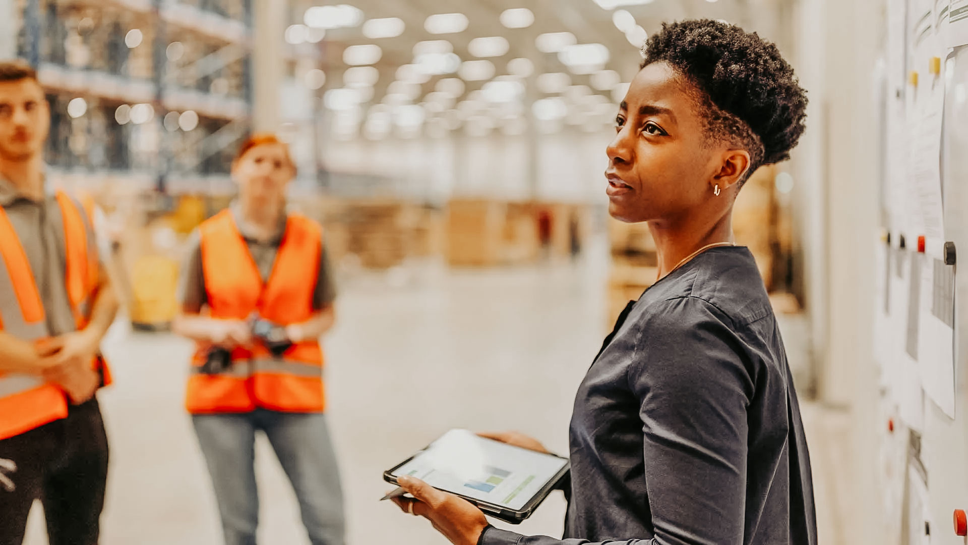 Safety meetings in the workplace. Supervisor leads a safety meeting on warehouse floor.