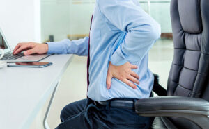 Man sitting in office with ergo injury