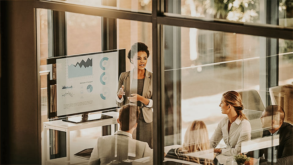 Woman presenting EHS and ESG data to a group of professionals