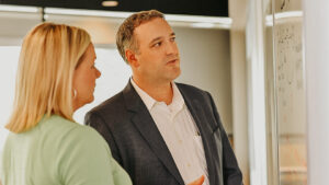 Management staff looking at whiteboard