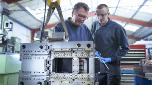 Employees Working Together on Machinery
