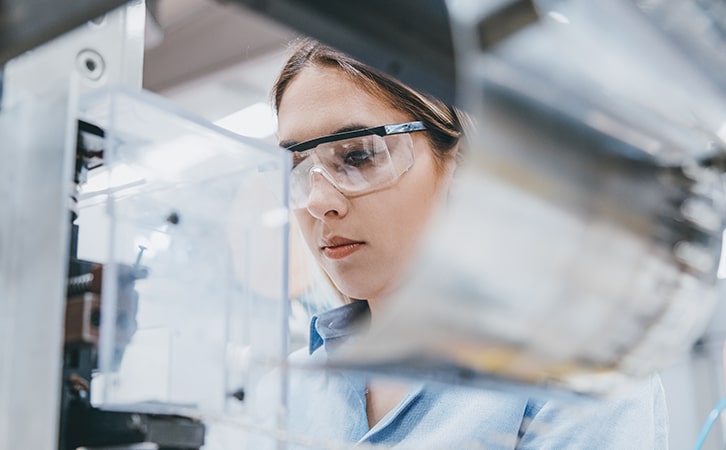 Female Worker Checking Machine