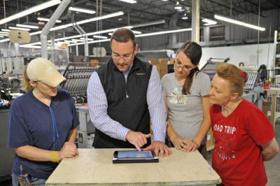 Team Checking Ebook on Tablet