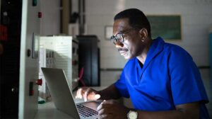 Man Working on Laptop At Night