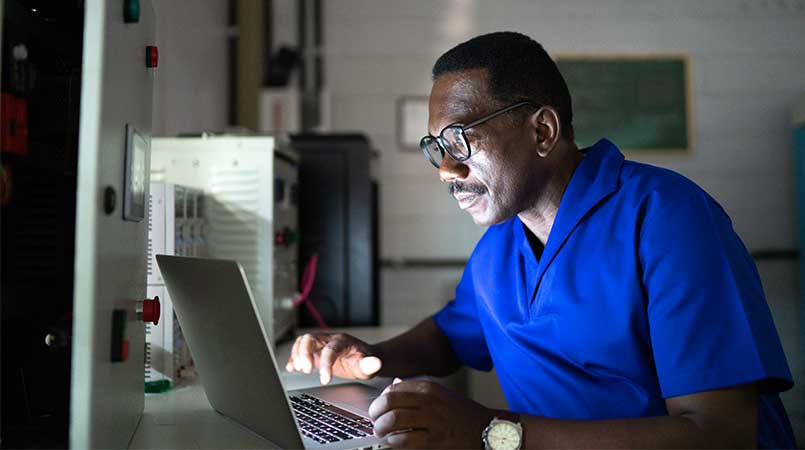 Man Working on Laptop At Night