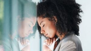 Woman Infront of Glass Thinking
