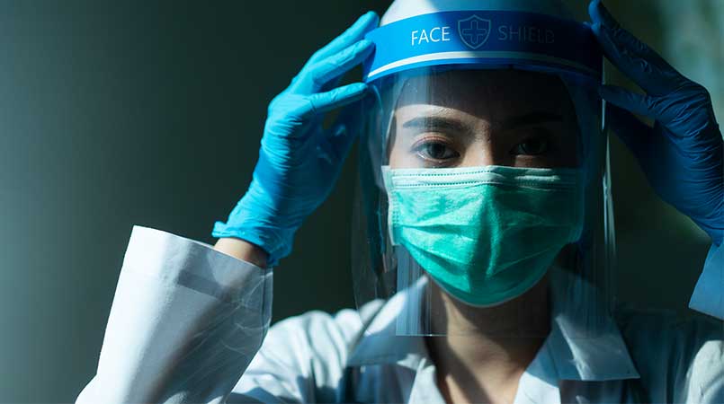 Woman With Face Shield and Gloves