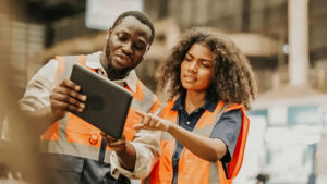 two safety professionals looking at Safety Observations software on an iPad