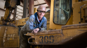 Factory Worker Next to Heavy Machine