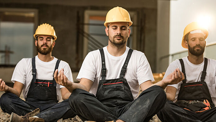 Construction workers meditating