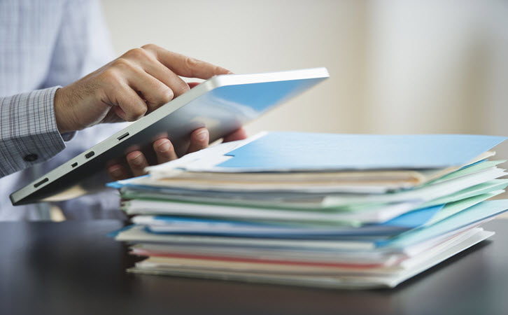 Man with Ipad and Folders