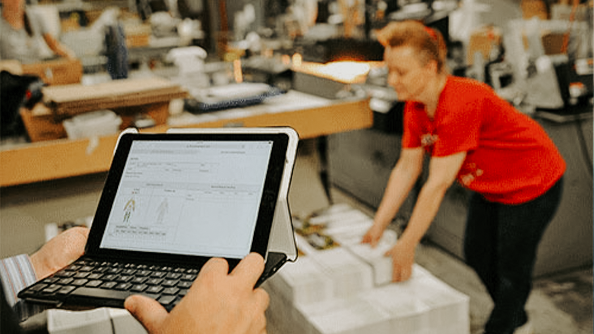 person using a tablet to review ergonomics data and MSD risk levels while watching an employee complete a task