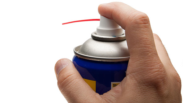 Man holding can of lubricant spray