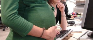 Pregnant women at work near office desk