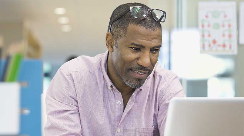 Man With Glasses Working on Computer 1