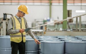 Male Engineer And Storage Tank At Manufacturing Factory