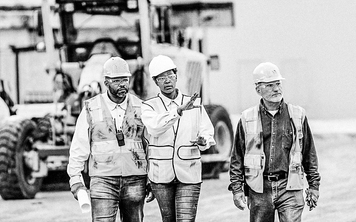 Woman Directing Construction Workers, Walking Thru Site