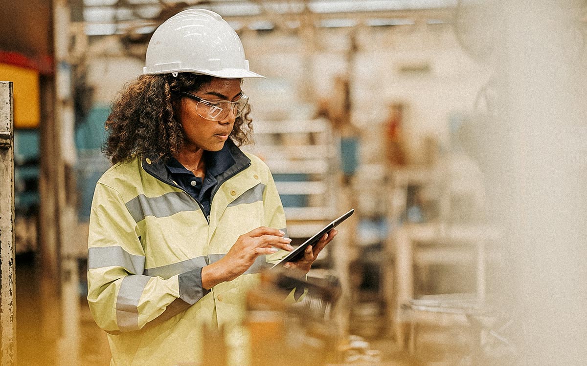 Managing Operations In Real Time By Using Shop Floor Control Management System. Female Production Engineer Using Tablet To Review Production Order Release And Capacity Of Machine Requirements In A Production Line.