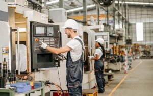 Engineer Using Factory Computer Control Panel Controlling Manufacturing System