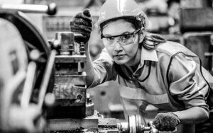 Portrait Of Female Engineer Standing With Confident Against Machine Environment In Factory