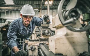 Male Engineer Operating Lathe Machine.