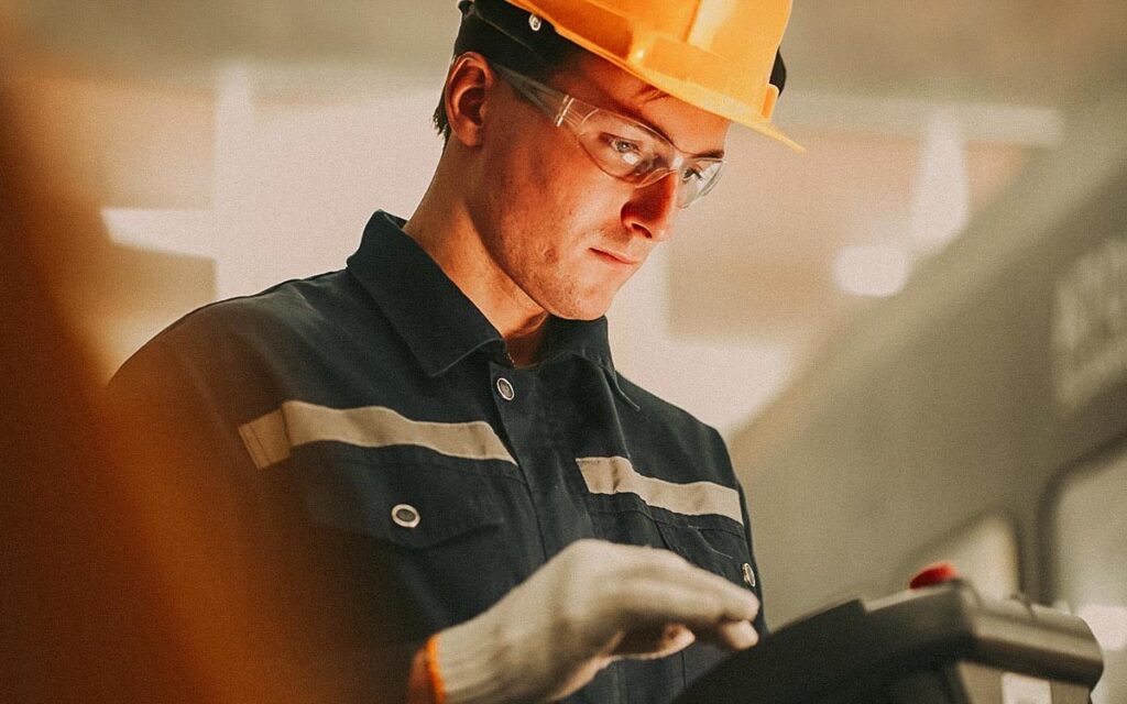 Engineers Working With Robot Machinery.
