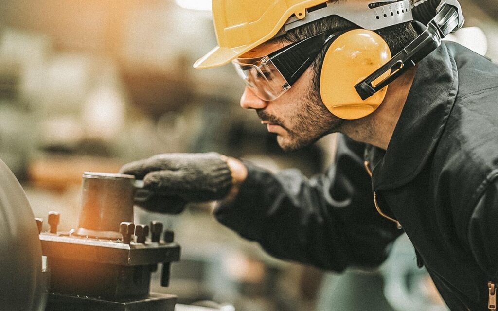 Industrial Engineers In Hard Hats.work At The Heavy Industry Manufacturing Factory.industrial Worker Indoors In Factory. Man Working In An Industrial Factory.safety First Concept.