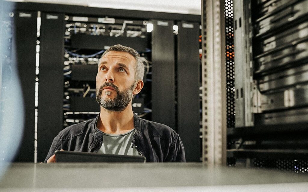 Male Technician Standing In Server Room