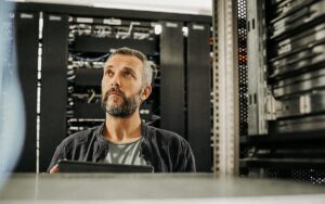 Male Technician Standing In Server Room
