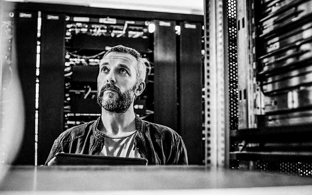 Male Technician Standing In Server Room