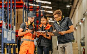 A Group Of Workers Working In A Warehouse.