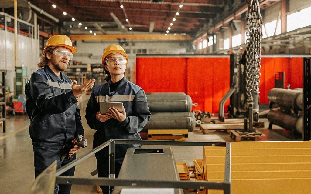 Explaining Coworker How To Use Industrial Crane