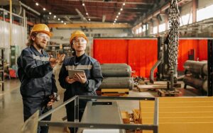Explaining Coworker How To Use Industrial Crane
