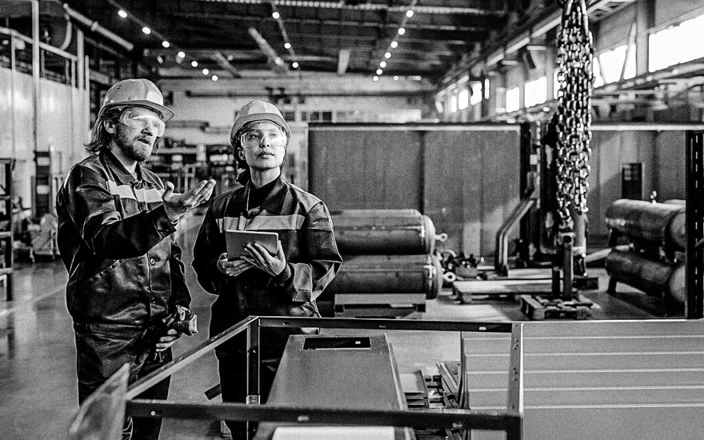 Explaining Coworker How To Use Industrial Crane